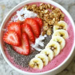 The strawberry spinach smoothie bowl is both vibrant and tasty. Here are the key ingredients you will need: - 1 cup fresh spinach leaves - 1 cup frozen strawberries - 1 ripe banana - 1/2 cup almond milk (or any milk of choice) - 1 tablespoon almond butter (or peanut butter) - 1 tablespoon chia seeds - 1/2 teaspoon vanilla extract These ingredients blend together to create a creamy base. Fresh spinach adds nutrients without a strong flavor. Frozen strawberries give you that sweet, fruity taste. The banana makes the texture smooth and helps with sweetness. Almond milk keeps it light and dairy-free, while almond butter adds a nice nutty touch. Chia seeds give a boost of fiber and omega-3s. Lastly, vanilla extract enhances the overall flavor. To make your smoothie bowl extra fun, you can add toppings: - Sliced fresh strawberries - Granola - Nuts - Coconut flakes - Honey These toppings not only add flavor but also add texture and visual appeal. Sliced strawberries brighten the bowl, while granola adds crunch. Nuts provide healthy fats, and coconut flakes give a tropical twist. A drizzle of honey can sweeten it further if you like a sweeter bowl. This smoothie bowl is packed with nutrition. It has about 250 calories per serving. You get a good mix of macronutrients: roughly 7 grams of protein, 10 grams of fat, and 40 grams of carbs. You will also find essential vitamins and minerals. Spinach brings iron and calcium, while strawberries add vitamin C. Bananas provide potassium, and chia seeds are rich in fiber. This bowl is not only delicious but also a healthful choice for breakfast or a snack. To make the Strawberry Spinach Smoothie Bowl, you start with fresh ingredients. Gather your items first. In a blender, combine: - 1 cup fresh spinach leaves - 1 cup frozen strawberries - 1 ripe banana - 1/2 cup almond milk - 1 tablespoon almond butter - 1 tablespoon chia seeds - 1/2 teaspoon vanilla extract Blend these ingredients on high. Keep blending until smooth and creamy. If the mixture feels too thick, add a bit more milk. This will help reach your desired consistency. Once it looks just right, pour the smoothie into a bowl. Now comes the fun part—adding toppings! Arrange your toppings to make it look nice. Use sliced strawberries, granola, nuts, and coconut flakes. Get creative! You can place them in patterns or piles. For extra sweetness, drizzle some honey on top. This will make your bowl pop with color and flavor. Enjoy this smoothie bowl any time of day. It works well for breakfast or as a snack. You can also serve it after a workout for a refreshing boost. The vibrant colors and flavors will brighten your day. Keep it simple, yet fancy, with your beautiful toppings. To make your smoothie bowl creamy, use frozen strawberries. They blend well and add chill. You can also add a ripe banana. This gives a smooth texture. If the mix is too thick, add more milk. Almond milk works great, but any milk is fine. Adjust sweetness based on your taste. If you prefer it sweeter, add honey or maple syrup. You can mix in more fruit, too. Taste as you go to find your perfect blend. When shopping, I suggest going for organic fruits. They often taste better and have fewer chemicals. For bananas, pick ones that are yellow with a few brown spots. This means they are sweet and ripe. For strawberries, look for bright red ones without white tips. These are usually the sweetest. One common mistake is over-blending. If you blend too long, it can get too runny. Blend just until smooth. Stop and check the texture often. Choosing the right milk is also key. Avoid heavy cream or whole milk if you're looking for a light bowl. Stick with almond milk or oat milk. They keep it light and healthy. For more details on making this bowl, check the Full Recipe. {{image_2}} You can switch up the flavors in your strawberry spinach smoothie bowl. Try adding fresh mango or blueberries. These fruits add sweetness and a burst of color. You can also use kale instead of spinach. Kale brings a different taste and packs a nutrient punch. Mixing fruits and greens keeps your bowl exciting. To boost nutrition, consider adding protein powder or yogurt. These ingredients help keep you full longer and add creaminess. You can also try different nut butters. Almond butter gives a mild taste, while peanut butter adds a rich flavor. Each option can change the smoothie bowl's taste. Using seasonal fruits makes a big difference in taste. In summer, use ripe peaches or cherries. In winter, opt for bananas or frozen berries. Fresh, in-season fruits taste better and are often more nutritious. You can also adapt your smoothie bowl to the weather. When it's cold, serve it warm by blending in a bit of hot water. On hot days, enjoy it cold and refreshing. This keeps your smoothie bowl fun all year long. For the full recipe, check out the details above. To store leftover smoothie bowls, place them in an airtight container. This helps keep the bowl fresh. Smoothie bowls taste best when eaten within 24 hours. If you want to enjoy it later, store it in the fridge. Avoid leaving it out for too long, as it may lose flavor and texture. You can freeze smoothie mixtures for future use. Pour the mixture into freezer-safe bags or containers. Remove as much air as you can to prevent freezer burn. When you're ready to enjoy it, thaw the smoothie overnight in the fridge. Blend it again for a smooth texture before serving. To keep spinach fresh, store it in a cool, dry place. Place strawberries in the fridge, unwashed, to extend their shelf life. Spinach lasts about five days, while strawberries stay good for up to a week. The smoothie bowl retains flavor for about one day in the fridge. After that, it may begin to lose its taste and nutrients. A Strawberry Spinach Smoothie Bowl is a delicious and healthy dish. It blends fresh spinach, frozen strawberries, and a ripe banana. You can add almond milk and almond butter for creaminess. Chia seeds and vanilla extract enhance the flavor and nutrition. This bowl is fun to eat and visually appealing with colorful toppings. Yes, you can easily make this smoothie bowl vegan. Use almond milk or any plant-based milk. Swap almond butter for peanut butter or sunflower seed butter. Ensure your toppings, like granola and honey, are vegan-friendly. This way, everyone can enjoy this tasty bowl. To achieve a thicker smoothie bowl, use frozen fruit instead of fresh. You can also add more spinach to the mix. Another tip is to reduce the amount of almond milk. Blend it until smooth, then check the texture. If it’s too thin, add more frozen fruit or greens. This will give you a creamy and satisfying bowl. This article explored the delicious world of strawberry spinach smoothie bowls. You learned about key ingredients, step-by-step preparation, and tips for perfecting your bowl. Presentation and storage methods ensure freshness and flavor. In summary, you can enjoy this healthy treat any time of day. Feel free to experiment with flavors and toppings. With practice, you’ll create a smoothie bowl that’s not just tasty, but also visually stunning. Enjoy your smoothie bowl adventure!