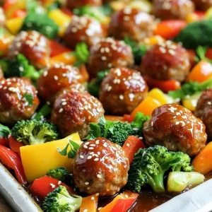 - 1 lb ground beef or turkey - 1/2 cup breadcrumbs - 1/4 cup grated Parmesan cheese - 1/4 cup fresh parsley, chopped - 2 cloves garlic, minced - 1/3 cup honey - 1/4 cup soy sauce - 1 tablespoon Dijon mustard - 1 teaspoon sesame oil - 1/2 teaspoon red pepper flakes - 2 cups mixed vegetables (bell peppers, broccoli, carrots) - Additional garnishes (sesame seeds, lime) You need fresh, simple, and tasty ingredients for these meatballs. You can use ground beef or turkey, depending on your taste. Breadcrumbs help bind the meatballs. Grated Parmesan gives them a nice flavor. Fresh parsley adds color and freshness. Lastly, minced garlic brings in that rich, savory taste. For the sauce, honey is key for sweetness. Soy sauce adds saltiness and depth. Dijon mustard gives a slight kick. Sesame oil offers a nutty flavor, while red pepper flakes add heat, if you want it spicy. You can add mixed vegetables for a complete meal. Bell peppers, broccoli, and carrots roast well and add color. For a nice touch, garnish with sesame seeds or a squeeze of lime before serving. This dish is fun to make and even more fun to eat! - Preheat your oven to 400°F (200°C). This helps the meatballs cook evenly. - Line a large sheet pan with parchment paper. This makes cleanup easy. - In a large mixing bowl, combine the ground beef (or turkey), breadcrumbs, Parmesan, parsley, minced garlic, beaten egg, salt, and pepper. Mix until everything is well blended. - Using your hands, form the mixture into meatballs. Aim for about 1 inch in size. - Place the meatballs evenly spaced on the sheet pan. This helps them cook properly. - In a small bowl, whisk together the honey, soy sauce, Dijon mustard, sesame oil, and red pepper flakes (if using). This sauce adds great flavor. - Drizzle the honey garlic sauce over the meatballs. Make sure each one is coated well. - Toss the mixed vegetables in the remaining sauce. Spread them around the meatballs on the pan. - Bake in the preheated oven for 20–25 minutes. The meatballs should reach an internal temperature of 165°F (74°C). - Check that the vegetables are tender. They should be lightly browned and flavorful. To make tender meatballs, start with ground beef or turkey. Use a mix of breadcrumbs and grated Parmesan cheese. The cheese adds flavor and moisture. Mix all ingredients gently. Overmixing can make meatballs tough. You can add more flavor with seasonings. Try garlic powder or Italian herbs. A pinch of red pepper flakes gives a nice kick. Fresh herbs, like parsley, make them bright and fresh. For roasting, bell peppers, broccoli, and carrots work great. These veggies cook well and add color. Cut them into even pieces for even cooking. To achieve the best tenderness, toss the veggies in the honey garlic sauce. This adds flavor and helps them cook perfectly. Spread them on the sheet pan with the meatballs for even roasting. For presentation, serve meatballs and veggies on a large platter. Garnish with extra parsley or sesame seeds for flair. A squeeze of fresh lime adds a zesty touch. Pair your dish with rice or noodles for a complete meal. You can also serve with a simple salad to balance the flavors. {{image_2}} You can switch up the meat for this recipe. Lean chicken works great too. It keeps the meal light and tasty. If you want a plant-based choice, use ground turkey or a meat substitute. These options can give you a similar flavor and texture. You can change the sweetness of the sauce. Use less honey if you want it less sweet. Mixing in some fresh lime juice can add a nice tang. For a different flavor, try teriyaki or barbecue sauce. These options can change the taste while keeping it fun. Feel free to use your favorite vegetables. Bell peppers, broccoli, and carrots are great, but so are zucchini and asparagus. Choose seasonal veggies for the best flavor. You can mix and match based on what you find fresh at your market. This keeps your dish vibrant and exciting. To keep your honey garlic meatballs fresh, store them in an airtight container in the fridge. This method keeps them safe to eat for up to four days. Make sure the meatballs cool down before sealing them in the container. If you want to save them for later, freezing is a great option. Place the meatballs in a single layer on a baking sheet first. Freeze them for about an hour until firm. Then, transfer them to a freezer bag or airtight container. They can last for up to three months in the freezer. Label the bags with dates to keep track of freshness. You have two good options for reheating: the microwave or the oven. If you use the microwave, place the meatballs on a microwave-safe plate. Heat them in 30-second intervals until they are hot. This method is fast but may make them a bit softer. For the oven, preheat it to 350°F (175°C). Place the meatballs on a baking sheet and cover with foil. Heat for about 15 minutes or until hot. This method keeps the meatballs firm and flavorful. No matter how you reheat them, enjoy your delicious meal! Yes, you can make the meatballs in advance. Form them and store them in the fridge for up to 24 hours. This saves time on busy nights. If you freeze them, place the meatballs on a tray first. Once they are firm, transfer them to a bag. They will keep for about three months. To keep meatballs intact, use a binder. Breadcrumbs and eggs help hold them together. Mixing the ingredients gently is key. Don't overwork the meat. Also, let them rest for a few minutes after forming. This helps them set up before cooking. Check the internal temperature. Meatballs should reach 165°F (74°C) to be safe. Use a meat thermometer for accuracy. The outside should be browned, and the inside should be firm. If you don't have a thermometer, cut one open. It should be no longer pink inside. Absolutely! You can switch up the sauce to your taste. Try teriyaki sauce for a sweet twist. Adding spices like garlic powder or onion powder can enhance the flavor. Be creative with herbs too. Basil or thyme can add a nice touch to your meatballs. You now have a clear plan for making tasty meatballs. From choosing ingredients to cooking techniques, you can create a great meal. Remember to try different meats, sauces, and veggies. Store leftovers wisely to enjoy another day. By following these steps and tips, you will impress everyone at your table. Enjoy the process and have fun!