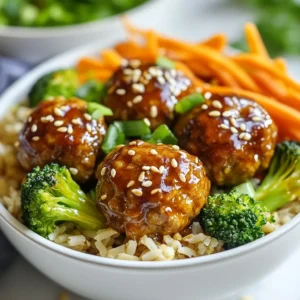 - 1 pound ground turkey - 1/4 cup breadcrumbs (preferably panko) - 1 egg, beaten - 2 tablespoons green onion, finely chopped - 1 tablespoon ginger, grated - 2 cloves garlic, minced - 1/3 cup teriyaki sauce - 1 tablespoon sesame oil - 2 cups cooked brown rice or quinoa - 1 cup broccoli florets - 1 cup carrots, julienned - Sesame seeds for garnish - Extra green onion for garnish - Preheat oven settings - Baking sheet and parchment paper - Large mixing bowl and skillet The main ingredients are simple and fresh. Ground turkey is lean and tasty. Breadcrumbs help bind the meatballs. An egg adds moisture and richness. Green onion, ginger, and garlic bring a nice kick. Teriyaki sauce adds sweetness and depth. Sesame oil gives a nutty flavor. For vegetables, I love using broccoli and carrots. They are colorful and healthy. Brown rice or quinoa makes a great base. The sesame seeds and extra green onion are perfect for garnish. They add crunch and flavor. Having the right cooking tools is key. Preheating the oven ensures even cooking. A lined baking sheet makes cleanup easy. A large bowl helps mix everything well. A skillet is great for cooking the veggies. With these ingredients and tools, you can make a tasty meal! {{ingredient_image_1}} - Preheat your oven to 400°F (200°C). - Line a baking sheet with parchment paper. - In a large bowl, combine 1 pound of ground turkey, 1/4 cup of breadcrumbs, and 1 beaten egg. - Add 2 tablespoons of finely chopped green onion, 1 tablespoon of grated ginger, 2 minced cloves of garlic, salt, and pepper to taste. - Mix everything together until well combined. - Shape the turkey mixture into meatballs, about 1 to 1.5 inches in size. - Place the meatballs on the lined baking sheet, leaving space between each one. - Bake in the preheated oven for 20-25 minutes, or until they reach an internal temperature of 165°F (74°C). - Heat 1 tablespoon of sesame oil in a large skillet over medium heat. - Add 1 cup of broccoli florets and 1 cup of julienned carrots to the skillet. - Sauté the vegetables for about 5-7 minutes until they are tender but still crisp. - Lower the heat and add 1/3 cup of teriyaki sauce to the skillet with the veggies. - Stir well to coat the vegetables and let them simmer for another 2-3 minutes. - Divide cooked brown rice or quinoa among bowls. - Top the rice or quinoa with the teriyaki veggies and meatballs. - Garnish with sesame seeds and extra green onion for a pop of flavor. To achieve the best texture for your meatballs, use ground turkey with some fat. Lean turkey can make them dry. A mix of breadcrumbs helps keep them moist. I recommend using panko for its lightness and crunch. Make sure to size your meatballs evenly. Aim for 1 to 1.5 inches in diameter. This helps them cook at the same rate. If they are too large, they may not cook through. If too small, they may dry out quickly. To keep your vegetables crisp, do not overcook them. Sauté the broccoli and carrots for just 5 to 7 minutes. They should be tender but still bright and crunchy. If you want to switch it up, try other veggies. Bell peppers, snap peas, or zucchini work great. Mix and match based on what you have on hand. You can use store-bought teriyaki sauce for quick meals. It saves time and is often tasty. However, making your own can add a special touch. To customize the flavor, add honey for sweetness or red pepper flakes for heat. You can also mix in sesame seeds or green onion for extra flavor. Experiment with what you like best! Pro Tips Chill the Mixture: Refrigerate the meatball mixture for about 30 minutes before forming into balls. This helps the meatballs hold their shape better while baking. Customize Your Veggies: Feel free to swap out the broccoli and carrots for your favorite vegetables like bell peppers or snap peas for a colorful bowl. Make Ahead: You can prepare the meatballs in advance and freeze them. Simply bake from frozen, adding an extra 5-10 minutes to the cooking time. Perfect Rice or Quinoa: For added flavor, cook your brown rice or quinoa in vegetable broth instead of water. {{image_2}} You can swap the ground turkey for ground chicken or beef. Both options work well with teriyaki sauce. If you want a vegetarian dish, try using chickpeas instead. Mash them lightly and mix with breadcrumbs. This way, you create a tasty meatball that everyone can enjoy. Change up the base grains for your bowls. Use quinoa for a nutty flavor or cauliflower rice for a lighter meal. You can also use noodles for a fun twist. If you need gluten-free options, quinoa is a great choice. Just make sure to read the labels when selecting noodles. You can use seasonal vegetables to keep your meal fresh. Bell peppers, snap peas, or zucchini all work great. They add color and crunch to your bowl. In spring, consider asparagus, and in fall, try roasted squash. These swaps keep your dish exciting and full of flavor. To keep your teriyaki turkey meatball bowls fresh, use airtight containers. Glass or plastic containers work well. Store the meatballs and veggies together, or separately if you prefer. This helps keep everything fresh. Place the containers in the fridge. They will stay good for up to three days. You can freeze the meatballs and veggies for later meals. First, let them cool completely. Then, place meatballs and veggies in freezer bags. Make sure to squeeze out as much air as you can. Label the bags with the date. They can last for up to three months in the freezer. To thaw, place the bags in the fridge overnight. You can also use the microwave on a low setting. To reheat your meal, keep the meatballs moist. You can do this by adding a splash of water or teriyaki sauce. Use the microwave or oven for reheating. In the microwave, heat for 1-2 minutes. In the oven, preheat to 350°F (175°C) and heat for about 10-15 minutes. Stir occasionally to avoid hot spots. Enjoy your delicious meal just like it was fresh! Teriyaki turkey meatball bowls can last in the fridge for about 3 to 4 days. Make sure to store them in an airtight container. This helps keep the meatballs and veggies fresh. When you are ready to eat, just reheat them thoroughly. Yes, you can make teriyaki turkey meatballs ahead of time. You can prepare the meatballs and cook them. After they cool, store them in the fridge or freezer. This makes meal prep easier for busy days. Just reheat them when you are ready to serve. You can use ground chicken or ground beef as a substitute for ground turkey. Both options work well in this recipe. If you want a vegetarian choice, try using mashed chickpeas or lentils. These alternatives still give you great flavor and texture. Most store-bought teriyaki sauces contain soy sauce, which often has gluten. However, you can find gluten-free teriyaki sauces made with tamari or coconut aminos. Always check the label to be sure. Making your own teriyaki sauce is also a great option. Yes, you can use frozen vegetables in this recipe. They are just as healthy and save you time. Just add them directly into the skillet, and cook until they are heated through. This makes your meal quick and easy while still being tasty. In this post, I shared a simple recipe for Teriyaki Turkey Meatball Bowls. You learned how to make rich meatballs with ground turkey and fresh veggies. I also gave tips on storage, cooking, and variations for different diets. I hope you feel confident to try this dish. It’s tasty, easy, and can fit any meal plan. Enjoy creating your own version!