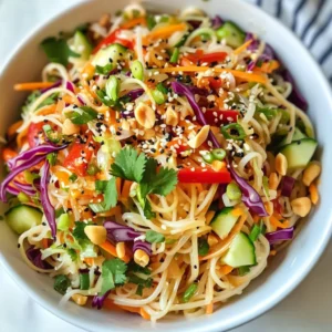 - 8 oz. rice noodles - 1 cup red bell pepper, julienned - 1 cup cucumber, julienned - 1 cup shredded carrots - 1 cup red cabbage, thinly sliced - 1/4 cup fresh cilantro, chopped - 1/4 cup green onions, sliced - 1/2 cup roasted peanuts, chopped The choice of ingredients makes this salad pop with color and flavor. Rice noodles are light and soak up the dressing well. Red bell pepper adds sweetness and crunch. Cucumber brings a refreshing bite. Shredded carrots and red cabbage add texture and color. Fresh cilantro and green onions offer a burst of freshness. Roasted peanuts give a nice crunch and nutty flavor. - 1/4 cup creamy peanut butter - 2 tablespoons soy sauce - 2 tablespoons sesame oil - 1 tablespoon rice vinegar - 1 tablespoon honey - 1 teaspoon sriracha (optional) - 1-2 garlic cloves, minced The dressing blends creamy and savory flavors. Peanut butter is the star, giving richness. Soy sauce adds saltiness, while sesame oil brings depth. Rice vinegar offers a tangy kick. Honey balances the salt and adds a hint of sweetness. Sriracha can spice things up if you like heat. Garlic enhances the overall flavor, making it truly delicious. {{ingredient_image_1}} To cook rice noodles, start by boiling water. Add 8 oz. of rice noodles and let them soak for 8-10 minutes. They should become soft and tender. After cooking, drain the noodles and rinse them under cold water. This stops the cooking and helps keep them firm. Set the noodles aside in a bowl. While the noodles soak, wash your veggies. For fresh ingredients, choose bright colors and firm textures. Julienning vegetables adds a nice crunch to the salad. For the red bell pepper and cucumber, cut them into thin strips. Shred the carrots and slice the red cabbage thinly. Place all the veggies in a big bowl for mixing. In a small bowl, mix together 1/4 cup of creamy peanut butter, 2 tablespoons of soy sauce, and 2 tablespoons of sesame oil. Add 1 tablespoon of rice vinegar and 1 tablespoon of honey for sweetness. If you like heat, stir in 1 teaspoon of sriracha. Mince 1-2 garlic cloves and add them to the mix. Whisk until smooth. If the dressing is too thick, add a tablespoon of warm water to thin it out. Next, add the drained noodles to your bowl of veggies. Pour the dressing over everything. Gently toss the noodles and veggies together. Make sure every piece gets coated well in the dressing. This keeps the flavors even throughout the salad. Now, it’s time for the fun part! Add 1/2 cup of chopped roasted peanuts, 1/4 cup of fresh cilantro, and 1/4 cup of sliced green onions to the salad. Fold these ingredients in gently to keep the peanuts crunchy. Give your salad a taste and adjust flavors as needed. You might want more soy sauce, honey, or even sriracha. To enhance the flavor, refrigerate the salad for at least 30 minutes. This chilling time allows the flavors to blend nicely. When you are ready to serve, take it out and enjoy the fresh, savory taste. It’s perfect for gatherings or a light meal! To add spice, try adding more sriracha to the dressing. You can also add red pepper flakes for extra heat. For sweetness, mix in more honey or use maple syrup. If you want a different flavor, consider using a sesame ginger dressing instead of the peanut dressing. It can give a fresh twist to the salad. Serve the salad in a large, colorful bowl for a fun look. You can also use individual plates for a fancy touch. Drizzle more sesame oil on top for shine. Sprinkle extra peanuts and fresh cilantro for a pop of color. This makes the dish more inviting and tasty. When cooking rice noodles, avoid overcooking. They should be tender, not mushy. Rinse them under cold water right after cooking to stop the cooking process. This helps keep their texture. For the veggies, cut them thin. This keeps them crunchy and vibrant. If you let them sit too long, they can lose their crispness. Toss them in just before serving to keep them fresh. Pro Tips Use Fresh Ingredients: The freshness of your vegetables will enhance the flavor and texture of the salad. Opt for crisp, vibrant vegetables for the best results. Adjust the Heat: If you enjoy a bit of spice, feel free to increase the amount of sriracha in the dressing. Alternatively, you can add red pepper flakes for a different heat profile. Customize Your Veggies: Feel free to substitute or add other vegetables like bell peppers, snap peas, or even avocado to personalize the salad to your taste. Meal Prep Friendly: This salad keeps well in the fridge for up to 3 days, making it a great option for meal prep. Just remember to add the peanuts right before serving to maintain their crunch. {{image_2}} You can add protein to your sesame peanut noodle salad in several ways. For meat lovers, grilled chicken or shrimp works well. Simply cook them, slice, and toss into the salad. If you prefer plant-based options, tofu is a great choice. Firm tofu absorbs flavor well and adds texture. You can also try tempeh or chickpeas for a hearty vegan alternative. These options boost protein without losing flavor. Feel free to mix up the veggies in your salad. You can add snap peas, broccoli, or bell peppers for crunch. Seasonal vegetables like asparagus in spring or zucchini in summer keep the salad fresh and exciting. Always look for the freshest produce. Fresh veggies enhance the taste and nutrients of your dish. The dressing is where you can get creative. Adjust the spice by adding more sriracha for heat or less for mildness. If you want a sweeter taste, add more honey. For dietary needs, you can swap out the peanut butter for almond or sunflower seed butter. This way, you keep the creamy texture while catering to allergies. Always taste your dressing before adding it to the salad, so you can tweak it just right. To keep your Sesame Peanut Noodle Salad fresh, place leftovers in an airtight container. This helps maintain the taste and crunch of the veggies. If you have a lot of salad, divide it into smaller portions. This way, you can grab what you need without exposing the whole batch to air. Always remember to let the salad cool down to room temperature before sealing it in the container. Your salad lasts about 3 to 4 days in the fridge. Check for signs of spoilage, such as a sour smell or slimy texture. If the veggies look wilted or the dressing separates too much, it's time to toss it out. Always trust your senses; if it doesn’t look or smell right, don’t eat it. Reheating this salad is not the best idea. The noodles can become mushy, and the veggies lose their crunch. If you want to enjoy leftovers, try serving them cold. You can also add a bit of fresh dressing to refresh the flavors. If you must heat it, do so gently in a pan over low heat. Avoid the microwave, as it can ruin the texture. Yes, you can use a different type of noodle. Rice noodles are great for this dish, but you can try others too. For a gluten-free option, use rice or quinoa noodles. Whole grain noodles also work well for added fiber. Choose what you enjoy most! Meal prepping this salad is easy. Start by chopping your veggies ahead of time. Store them in separate containers to keep them fresh. You can also cook the noodles and keep them in the fridge. Mix everything when you are ready to eat! Yes, you can make this salad in advance! Prep the veggies and noodles the day before. Keep the dressing in a separate container. Mix everything together right before you serve. This keeps the salad fresh and crunchy. This salad can be made kid-friendly! Cut the veggies into smaller pieces for easier eating. You can also reduce the sriracha or skip it if your kids don’t like spice. Let them help mix the salad for fun and engagement. To add more flavor, try these tips. You can add more soy sauce or honey for sweetness. Marinate the veggies in a bit of sesame oil before mixing. You can also sprinkle in some lime juice for a zesty kick! This article covered how to make a sesame peanut noodle salad from start to finish. You learned about the key ingredients, a step-by-step guide for preparation, and tips for variations and storage. Overall, this dish is fresh, flavorful, and easy to customize. Experiment with different veggies or proteins to make it your own. Whether you're prepping for a meal or serving at a gathering, this salad will impress. Enjoy the process and the tasty results!