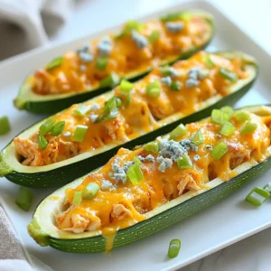 - 4 medium zucchinis - 1 lb cooked chicken breast, shredded - ½ cup buffalo sauce (adjust for spice preference) - 1 cup cheddar cheese, shredded - ½ cup cream cheese, softened - ½ cup green onions, chopped (plus extra for garnish) - 1 tablespoon olive oil - Salt and pepper to taste - Optional: Blue cheese crumbles for topping You can change the ingredients based on what you have. Use ground turkey if you prefer. Cooked rotisserie chicken works well in a pinch. For a spicier kick, swap buffalo sauce for a hotter brand. If you want to cut calories, use low-fat cream cheese. You can even use dairy-free cheese for a vegan twist. Feel free to add other veggies like bell peppers or corn for more flavor. Each serving of Buffalo Chicken Zucchini Boats has about: - Calories: 320 - Protein: 30g - Fat: 18g - Carbohydrates: 8g - Fiber: 2g These numbers can change based on your ingredient choices. Zucchini is low in calories and high in water. It helps keep you full without the extra calories. The chicken adds protein, which is great for muscle health. The cheese gives you calcium, too. Enjoy this meal guilt-free! {{ingredient_image_1}} First, get your oven ready. Preheat it to 375°F (190°C). Next, take your zucchinis. Slice each one in half lengthwise. Use a spoon to scoop out some flesh. Leave about 1/4-inch of the flesh for support. This makes a boat shape for the filling. Now, brush the inside with olive oil. Sprinkle some salt and pepper for flavor. In a mixing bowl, add the shredded chicken. Pour in the buffalo sauce and cream cheese. Then, mix in ½ cup of cheddar cheese and the chopped green onions. Stir well until everything combines. This mixture will be the star of your zucchini boats. Take the zucchini from the oven after 10-12 minutes. Carefully flip each half over. Now, generously spoon the buffalo chicken mixture into the zucchini. Don't worry if it gets a bit messy; that's part of the fun! Top each filled boat with the remaining cheddar cheese. If you like, add blue cheese crumbles on top. Return the boats to the oven for another 15-20 minutes. Bake until the cheese is bubbly and golden. Once done, let them cool for a few minutes. Garnish with extra green onions before serving. Enjoy! When picking zucchini, look for ones that are firm and shiny. A good zucchini should feel heavy for its size. Check for smooth skin and avoid any with soft spots. Choose medium-sized zucchinis, as they have the best flavor. If they are too big, they can be watery and less tasty. Buffalo sauce can be spicy. If you like it milder, use less sauce. Mix in some cream cheese to tone down the heat. You can also add honey for a sweet touch. If you want more heat, add extra buffalo sauce or a pinch of cayenne pepper. Always taste as you go to find your perfect balance. Cheddar cheese is great, but you can switch it up. Try mozzarella for a gooey texture. Crumbled feta adds a tangy taste. For a dairy-free option, use vegan cheese. Blue cheese crumbles make a bold choice if you like strong flavors. Mix and match to find what you love best. Pro Tips Choose the Right Zucchini: Look for firm zucchinis that are medium-sized for the best texture and flavor in your boats. Customize the Spice Level: Adjust the amount of buffalo sauce according to your heat preference, or try mixing in some ranch seasoning for a milder taste. Use Leftover Chicken: This recipe is a great way to use up leftover rotisserie chicken or any cooked chicken you have on hand, saving you time and effort. Garnish for Flavor: Don't skip the green onion garnish; it adds a fresh crunch that balances the richness of the cheese and cream cheese. {{image_2}} You can easily make Buffalo chicken zucchini boats vegetarian or vegan. Instead of chicken, use shredded jackfruit or chickpeas. Both options soak up flavors well. For the sauce, try a vegan buffalo sauce. Replace cream cheese with a vegan cream cheese or cashew cream. Use vegan cheese or skip it altogether for a lighter dish. You can switch up the meat to suit your taste. Ground turkey or beef works great in this dish. Shredded rotisserie chicken is another easy option. For a spicy kick, add some chorizo or sausage. Each meat will give a unique flavor to your zucchini boats. Want to mix things up? Try using barbecue sauce instead of buffalo sauce. This gives a sweet and smoky flavor. You can also add ranch seasoning for a creamy twist. If you like it spicy, add jalapeños or hot sauce. The best part is you can customize these boats to your liking! To keep your Buffalo Chicken Zucchini Boats fresh, let them cool first. Place them in an airtight container. They stay tasty in the fridge for about 3 to 4 days. If you want to enjoy them later, just make sure to store them without any extra toppings. When you're ready to eat the leftovers, preheat your oven to 350°F (175°C). Place the zucchini boats on a baking sheet. Cover them with foil to keep them moist. Heat for about 15-20 minutes or until warm. You can also reheat them in the microwave for 2-3 minutes, but the oven keeps them crispier. You can freeze the zucchini boats if you want to save some for later. First, prepare them as usual but do not bake. Wrap each boat tightly in plastic wrap or foil. Place them in a freezer-safe bag or container. They will last in the freezer for up to 3 months. When you're ready to enjoy, thaw them overnight in the fridge. Bake as directed for a quick weeknight meal! No, using raw chicken is not safe. You need cooked chicken for the filling. The heat from baking will not cook raw chicken properly in this dish. If you want to use raw chicken, cook it first. Shred it after cooking. This way, you’ll ensure the chicken is safe and tasty. Buffalo Chicken Zucchini Boats pair well with many sides. Here are some ideas: - A fresh garden salad - Creamy coleslaw - Garlic bread - Roasted sweet potatoes These sides complement the spicy buffalo flavor. They also add variety to your meal. You can mix and match based on your tastes. You can tell when zucchini is cooked by its feel. It should be tender but not mushy. After baking, poke it gently with a fork. If it goes in easily, it's done. The edges should look slightly golden. This means your zucchini boats are ready for the cheesy, spicy filling! This article covers the tasty Buffalo Chicken Zucchini Boats. We looked at key ingredients, substitutions, and nutrition facts. I shared step-by-step cooking tips and tricks for choosing the best zucchini. You can adjust spice levels and explore meat or vegan options, too. I also explained how to store and reheat leftovers. In conclusion, these zucchini boats offer a fun and healthy meal. Try different flavors and enjoy!