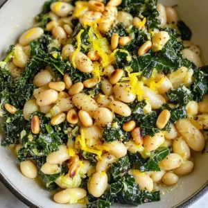 To make a tasty Tuscan kale white bean skillet, gather these simple ingredients: - Tuscan kale (1 bunch) - White beans (1 can, 15 oz) - Onion (1 medium, diced) - Garlic (3 cloves, minced) - Red pepper flakes (1 teaspoon) - Vegetable broth (1 cup) - Olive oil (2 tablespoons) - Salt and pepper to taste - Lemon (1, zested and juiced) - Grated Parmesan cheese (optional, for serving) - Toasted pine nuts (for garnish) These ingredients come together to create a dish that is not just easy to make, but also packed with flavor. The Tuscan kale adds a rich, earthy taste. The white beans provide a creamy texture and protein. The garlic and onion give a savory base, while the lemon zest adds brightness. Use fresh ingredients for the best taste. Enjoy the process of cooking with these vibrant ingredients! {{ingredient_image_1}} - Warm 2 tablespoons of olive oil over medium heat in a large skillet. - Sauté 1 medium diced onion for about 5 minutes until it becomes translucent. - Incorporate 3 minced garlic cloves and 1 teaspoon of red pepper flakes. - Cook for another minute until you smell the fragrant mix. - Add 1 bunch of chopped Tuscan kale and 1 cup of vegetable broth. - Cover the skillet and let the kale wilt for about 4-5 minutes. - Stir in 1 can (15 oz) of drained white beans, along with lemon zest and juice. - Season with salt and pepper to taste, then warm through for 3-4 minutes. How to choose fresh Tuscan kale When you pick Tuscan kale, look for vibrant green leaves. Avoid yellow or brown spots. The leaves should feel firm and crisp. Fresh kale has a slight sheen, showing it’s full of moisture. Choose a bunch with thick stems for the best flavor and texture. Adjusting spice level with red pepper flakes Red pepper flakes add a nice kick to this dish. Start with one teaspoon if you like mild heat. For more spice, feel free to add more. Mix the flakes with the garlic for a burst of flavor. Just remember, a little goes a long way, so taste as you go. Ideas for presenting the dish Serving this dish can be fun and simple. You can place the skillet right on the table. This gives a warm, rustic feel. Alternatively, serve it in individual bowls for a personal touch. Drizzle some olive oil and add extra lemon zest for brightness before serving. Optional garnishes for enhanced flavor To make this dish even better, consider garnishing it. Toasted pine nuts add a lovely crunch. Grated Parmesan cheese brings a rich flavor. You can also sprinkle fresh herbs like parsley or basil for a fresh touch. These little extras elevate the overall taste. Pro Tips Fresh Kale Matters: For the best flavor and texture, use fresh Tuscan kale. Look for vibrant, dark green leaves without any yellowing or wilting. Enhance the Flavor: Consider adding a splash of balsamic vinegar or a pinch of smoked paprika for an extra depth of flavor that complements the beans and kale. Perfectly Toasted Nuts: Toast your pine nuts in a dry skillet over low heat for a few minutes until golden brown. This brings out their natural oils and enhances their nutty flavor. Meal Prep Friendly: This dish stores well in the refrigerator for up to 3 days. Reheat gently to enjoy as a quick meal or side dish throughout the week. {{image_2}} To make this dish vegan, skip the Parmesan cheese. You can add nutritional yeast for a cheesy flavor. For gluten-free needs, ensure the vegetable broth is certified gluten-free. Most brands are safe. You can easily boost protein by adding chicken or sausage. Just cook it first in the skillet. Once it's done, follow the main recipe steps. You can also add other veggies like bell peppers or carrots. They add color and nutrients. Mix in some cherry tomatoes for sweetness. Just toss them in with the kale for extra flavor. To store your Tuscan kale white bean skillet, let it cool first. Place it in a sealed container. Keep it in the fridge for up to three days. If you want to keep it longer, you can freeze it. Use a freezer-safe container or bag. This way, it can last for up to three months. When you are ready to eat, you can reheat it in a pan. Heat it over medium heat for about 5 to 7 minutes. Stir it often to keep it from sticking. You can also use a microwave. Heat it in short bursts of 1 to 2 minutes. Stir between bursts to ensure even warming. Aim for 165°F to keep it safe and tasty. Tuscan kale lasts about 5 to 7 days in the fridge. Keep it in a bag or container. Make sure it is dry to prevent wilting. Yes, you can make this dish ahead of time. It stores well in the fridge for up to 3 days. Reheat it gently on the stove or in the microwave. This helps keep the flavors fresh. Kale is rich in vitamins A, C, and K. It also has antioxidants that help fight disease. White beans provide protein and fiber. They help with digestion and can keep you full longer. Together, they make a healthy, balanced meal. In this blog post, we explored how to make a nutritious dish featuring Tuscan kale and white beans. I shared ingredients, step-by-step instructions, and valuable tips to enhance your cooking. Remember, you can adapt the recipe for different diets and store leftovers properly. Enjoy this simple dish packed with flavor and health benefits. I hope you try this recipe and make it your own! Happy cooking!