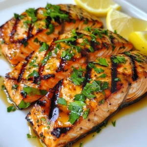 To make honey garlic grilled salmon, you will need: - 4 salmon fillets, skin on - 1/4 cup honey - 3 cloves garlic, minced - 2 tablespoons soy sauce (low-sodium) - 1 tablespoon olive oil - 1 teaspoon fresh ginger, grated - 1 tablespoon lemon juice - Salt and pepper to taste - Fresh parsley, chopped (for garnish) - Lemon wedges (for serving) These ingredients create a yummy balance of sweet and savory. The honey adds a nice glaze. Garlic and ginger give it a warm, fragrant kick. The soy sauce adds depth and saltiness. If you don't have some ingredients, here are swaps to try: - Maple syrup can replace honey for a different sweet flavor. - You can use garlic powder if you don’t have fresh garlic. - Coconut aminos works as a soy sauce substitute for a gluten-free option. - Grapeseed oil can substitute olive oil if needed. These options keep your dish delicious while fitting your pantry. When buying salmon, look for bright, shiny skin. Fresh salmon should smell like the ocean, not fishy. Choose fillets with a clear, pink color and moist texture. Avoid any that look dull or have brown spots. If possible, buy wild-caught salmon. It often tastes better and is healthier. With these tips, you can choose the best salmon for your meal. Enjoy cooking! {{ingredient_image_1}} Start by mixing your marinade. In a medium bowl, whisk together: - 1/4 cup honey - 3 cloves garlic, minced - 2 tablespoons soy sauce (low-sodium) - 1 tablespoon olive oil - 1 teaspoon fresh ginger, grated - 1 tablespoon lemon juice - Salt and pepper to taste This mix creates a sweet and savory flavor. Place the salmon fillets in a shallow dish. Pour the marinade over the salmon. Make sure all fillets are coated well. Cover with plastic wrap and refrigerate. You can let it marinate for 30 minutes to 2 hours. Longer marinating gives more flavor. Next, get your grill ready. Preheat it to medium-high heat. This helps the salmon cook evenly. Before you place the salmon on the grill, oil the grill grates lightly. This step prevents sticking. You can use a paper towel dipped in oil. Just be careful not to burn yourself! Now it’s time to grill! Carefully remove the salmon from the marinade. Let any excess marinade drip off. Place the fillets skin-side down on the grill. Grill them for about 5-7 minutes. Don’t move them around; let them cook and get nice grill marks. When they easily lift off the grill, it’s time to flip them. Grill the other side for 3-5 minutes. Check if the salmon flakes easily with a fork. When it’s done, take it off the grill and let it rest for a couple of minutes. This resting time keeps it moist. Serve each fillet hot, garnished with chopped parsley and lemon wedges for extra zest. Enjoy your delicious meal! For the best flavor, let your salmon marinate. I recommend at least 30 minutes. If you have time, marinate for 2 hours. The honey and garlic blend well, and the salmon absorbs these flavors. Use fresh garlic and ginger; they offer the best taste. Always check the salt in your marinade. It should enhance, not overpower. Cooking times depend on the thickness of your salmon. For 1-inch fillets, grill for 5-7 minutes on one side. Flip and grill for 3-5 more minutes. If your fillets are thicker, add a few more minutes. A good tip is to look for the fish to flake easily with a fork. Serve your honey garlic salmon with fresh lemon wedges. They add a nice burst of flavor. I love pairing it with steamed veggies or a fresh salad. Rice or quinoa also work well for a full meal. Garnish with chopped parsley for color and taste. Enjoy your meal with a glass of white wine for a lovely touch. Pro Tips Marinate for Maximum Flavor: Allow the salmon to marinate for at least 1 hour, or up to 2 hours, to infuse it with the delicious honey-garlic flavor. Grill Skin-Side Down: Start grilling with the skin side down to protect the delicate flesh of the salmon and achieve crispy skin. Check for Doneness: Use a fork to test if the salmon flakes easily. For medium doneness, the center should still be slightly translucent. Serve with Fresh Ingredients: Enhance the dish by serving with fresh herbs and lemon wedges for a bright, zesty finish. {{image_2}} You can switch up the flavor of the salmon with different marinades. Here are some ideas: - Maple Mustard: Use maple syrup and Dijon mustard for a sweet and tangy taste. - Citrus Herb: Mix orange juice, lime juice, and fresh herbs like thyme or dill. - Spicy Sriracha: Add sriracha sauce and a bit of lime for a spicy kick. Each marinade brings its own charm, helping you enjoy salmon in new ways. While grilling is great, you can also bake or pan-sear the salmon. - Baking: Preheat the oven to 400°F (200°C). Place marinated salmon on a baking tray and bake for 12-15 minutes. - Pan-Seering: Heat a pan over medium heat with a bit of olive oil. Cook salmon for about 5-6 minutes on each side, until golden brown. Both methods yield delicious results and keep the salmon moist. Serving sides can elevate your meal. Here are some tasty options: - Grilled Asparagus: Toss asparagus with olive oil, salt, and pepper. Grill them alongside the salmon. - Coconut Rice: Cook rice with coconut milk for a creamy side. - Fresh Salad: Mix greens with cherry tomatoes, cucumber, and a light vinaigrette. These sides complement the salmon's sweet and savory flavors, making each bite delightful. Store leftover salmon in an airtight container. Make sure it is cool before sealing. Place the container in the fridge. Leftover salmon stays fresh for up to three days. If you want to keep it longer, freezing is a great option. To reheat salmon, use the oven or a skillet. For the oven, preheat to 275°F (135°C). Place the salmon on a baking sheet and cover it with foil. Heat for about 15 minutes. For a skillet, add a small amount of oil over medium heat. Cook each side for 2-3 minutes. This keeps the salmon moist and tasty. If you freeze honey garlic salmon, wrap each fillet tightly in plastic wrap. Then place them in a freezer bag. Squeeze out as much air as possible. Frozen salmon can last up to three months. When ready to eat, thaw it in the fridge overnight before reheating. This keeps the flavor and texture intact. Yes, you can use other fish. Tilapia, trout, or cod work well. Each fish has a different taste. Choose a firm fish so it holds up on the grill. Adjust the cooking time based on thickness. Thinner fish may cook faster. For the best flavor, marinate the salmon for 30 minutes. You can marinate up to 2 hours. This gives the fish time to soak in the honey and garlic flavors. Don’t marinate too long or the fish may become mushy. The best way to check if salmon is cooked is to look for color. The flesh should change from bright pink to opaque. You can also use a fork to test it. If it flakes easily, it is done. The internal temperature should reach 145°F (63°C) for safety. This blog post shared the best ways to make honey garlic grilled salmon. We explored essential ingredients, tips for fresh salmon, and marinating steps. I provided grilling techniques for flaky fish, serving ideas, and cooking times. You can even try variations like baking or using different marinades. Remember to store leftovers right and handle them safely. Making this dish can be fun and rewarding. Tailor it to your taste, and enjoy grilled salmon that’s bursting with flavor. Happy cooking!
