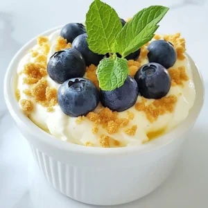 To make this tasty dip, gather these simple ingredients: - 8 oz cream cheese, softened - 1/2 cup powdered sugar - 1/4 cup sour cream - 2 tablespoons lemon juice - Zest of 1 lemon - 1/2 teaspoon vanilla extract - 1 cup fresh blueberries - Graham cracker crumbs (for serving) - Fresh mint leaves (for garnish) If you want to change things up, consider these swaps: - Use Greek yogurt instead of sour cream for a tangy twist. - Replace cream cheese with a dairy-free cream cheese for a vegan option. - Try honey or agave syrup instead of powdered sugar for a natural sweetener. Fresh blueberries are key to this dip. They add great flavor and color. Their sweetness balances the tangy lemon. You can use frozen blueberries, but fresh ones taste better. Plus, they make the dip look lively! Always choose plump, firm blueberries for the best results. Rinse them gently before use. {{ingredient_image_1}} To start, gather all your ingredients. You will need: - 8 oz cream cheese, softened - 1/2 cup powdered sugar - 1/4 cup sour cream - 2 tablespoons lemon juice - Zest of 1 lemon - 1/2 teaspoon vanilla extract - 1 cup fresh blueberries - Graham cracker crumbs (for serving) - Fresh mint leaves (for garnish) First, take a mixing bowl and beat the cream cheese. Use an electric mixer for this step. Mix until the cream cheese is creamy and smooth. Next, slowly add in the powdered sugar. Keep mixing until it is well blended. Now, add the sour cream, lemon juice, lemon zest, and vanilla extract to the bowl. Mix everything until smooth. This is where the magic happens! After that, gently fold in the fresh blueberries. Make sure to save some blueberries for garnish later. Transfer the dip into a serving bowl. Top it off with graham cracker crumbs for extra texture. Finally, add more blueberries on top and a few mint leaves for a pop of color. Your dip is now ready to serve! For the best texture, let the cream cheese soften. If it’s too hard, it won’t mix well. You can also use a hand mixer for more control. Mix slowly at first to avoid splatter. When adding powdered sugar, do it gradually. This will help keep the mix smooth. Don’t rush the mixing process. Take your time to ensure everything blends well. Folding in the blueberries is key. Be gentle so they don’t break apart. This keeps the dip looking nice and fresh. Serve the dip with graham crackers, fruit slices, or pretzels. Each option adds a fun crunch. For an extra touch, use a nice serving bowl. This can make your dip look more appealing. You can also arrange the graham crackers around the dip. This creates an inviting spread. Add a few extra mint leaves on the side for a fresh look. For a fun twist, consider pairing the dip with a variety of fruits. Sliced strawberries or apples work great. They add color and flavor to your platter. Enjoy your delicious Lemon Blueberry Cheesecake Dip! To get the smoothest dip, use soft cream cheese. You can leave it out for 30 minutes before mixing. This step makes it easier to blend. Use an electric mixer on medium speed to mix. This will help break up any lumps. Mix the cream cheese alone first, then add the other ingredients. This order helps keep the dip creamy. You can boost flavor with a touch more lemon juice or zest. This adds brightness to the dip. For a colorful twist, add more blueberries. They not only taste great but also look nice. To make it pretty, place extra blueberries on top. A few mint leaves add a fresh touch. Use graham cracker crumbs for a nice crunch. They also add a fun look to the dip. Do not rush the mixing process. If you mix too fast, lumps can form. Avoid using cold cream cheese; it will not blend well. Do not forget to reserve some blueberries for garnish. This adds a nice finishing touch. Lastly, don’t skip the graham cracker crumbs. They make the dip more enjoyable to eat. Pro Tips Use Room Temperature Cream Cheese: This ensures a smoother texture, making it easier to blend with the other ingredients. Add Zest for Extra Flavor: The zest of the lemon not only enhances the lemon flavor but also adds a delightful aroma to the dip. Chill Before Serving: Allowing the dip to chill in the fridge for at least an hour before serving helps the flavors to meld together beautifully. Experiment with Dippers: While graham crackers are classic, try serving the dip with fruit slices or pretzels for a fun twist. {{image_2}} You can change the fruit in this dip to suit your taste. Try strawberries or raspberries for a new twist. Peaches and blackberries also work well. Just keep the same amount of cream cheese and sour cream. This keeps the base creamy and delicious. Mix in the new fruit gently to keep them whole. You’ll create a colorful and tasty dip! If you want a gluten-free option, use gluten-free graham crackers. Many brands offer them, so you can still enjoy that crunch. Serve the dip with fresh fruit slices too. Apples and pears taste great with this dip. You can also use rice cakes or pretzels made without gluten. They add a fun twist and keep it safe for everyone. For a dairy-free option, swap the cream cheese with a dairy-free cream cheese. Look for brands made from nuts or soy. Use coconut cream instead of sour cream for a rich flavor. You can also add more lemon juice to keep the taste bright. This way, everyone can enjoy this tasty treat without the dairy! To keep your Lemon Blueberry Cheesecake Dip fresh, place it in an airtight container. Make sure the lid seals tightly. This helps keep the dip from drying out. Store it in the fridge. The dip can last up to 3 days. I suggest using glass or plastic containers with tight lids. Glass containers are great because they do not absorb smells. If using plastic, pick BPA-free options. These containers keep the dip fresh and safe to eat. You can use leftover dip in fun ways! Spread it on toast for a sweet breakfast. Use it as a topping for pancakes or waffles. You can also mix it with yogurt for a quick snack. The options are endless! Yes, you can make this dip ahead of time. I often prepare it a few hours before serving. It tastes great when chilled. Just cover it and place it in the fridge. The flavors mix and become even better. You have many tasty options for serving this dip. I recommend using graham crackers for a classic choice. Fresh fruit slices, like strawberries or apples, also work well. Pretzels add a nice crunch and saltiness. Mix and match to find your favorite pairings. This dip can last up to three days in the fridge. Make sure to store it in an airtight container. If you notice any change in smell or color, it's best to toss it. Enjoy your dip while it's fresh for the best taste! Making Lemon Blueberry Cheesecake Dip is simple and fun. We explored key ingredients, like fresh blueberries, to enhance flavor. The step-by-step guide ensured you understand each part of the process. Tips helped you create a creamy dip without mistakes. Variations let you customize for different diets. Remember to store leftovers properly so they stay fresh. Now, you can impress anyone with this tasty treat. Enjoy making your dip and sharing it with friends!
