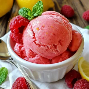 To make Raspberry Lemonade Sorbet, you need the best ingredients. Here’s what you’ll need: - 2 cups fresh raspberries - 1 cup granulated sugar - 1 cup water - 1 cup freshly squeezed lemon juice (about 4-5 lemons) - Zest of 1 lemon - Pinch of salt Using fresh ingredients is key. Fresh raspberries give your sorbet a bright flavor. They add a sweet and tangy taste that frozen ones can't match. Fresh lemon juice is also crucial. It brings a zesty punch, making the sorbet refreshing. Always choose ripe, vibrant fruit for the best results. When measuring raspberries, use a dry measuring cup. Gently fill the cup with raspberries, but don’t pack them down. This keeps them whole and juicy. If you crush them while measuring, you may get less fruit in your sorbet. Fresh lemon juice is vital for this recipe. Always squeeze your lemons just before using them. This ensures you get the best flavor. Bottled lemon juice can lose some of its fresh taste. So, stick to the real thing whenever possible. {{ingredient_image_1}} To make simple syrup, start by combining sugar and water in a medium saucepan. Heat it over medium heat. Stir the mixture until the sugar dissolves completely. You will know it's ready when the liquid is clear. Once done, remove it from heat and let it cool for a few minutes. Cooling is important. If you add hot syrup to your mixture, it can change the texture. Next, we need to prepare the raspberry puree. Place the fresh raspberries into a food processor or blender. Blend them until they are smooth. To get the best flavor, be sure to use ripe raspberries. After blending, strain the mixture through a fine mesh sieve. This step removes the seeds. Use a spatula to press down on the pulp. This helps extract as much puree as possible. Now, it’s time to mix everything together. In a large mixing bowl, combine the raspberry puree with lemon juice, lemon zest, and a pinch of salt. The lemon juice adds a bright flavor. Pour in the cooled simple syrup next. This step is key, so stir well. A good mix ensures that all the flavors blend together nicely. For the churning process, you have two options. If you have an ice cream maker, transfer the mixture into it. Churn according to the manufacturer's instructions. You want the sorbet to reach a soft-serve consistency. If you don’t have an ice cream maker, don’t worry! Pour the mixture into a shallow dish and freeze it. Stir the mixture every 30 minutes for about 2-3 hours. This helps break up any ice crystals. You want a smooth and creamy texture. To make smooth sorbet, start with fresh raspberries. Use ripe and juicy ones for the best taste. Blend the raspberries until they are fully pureed. Strain the puree to remove seeds. This step helps ensure a silky texture. Preventing ice crystals is key for a smooth sorbet. Use simple syrup made from sugar and water. This syrup helps keep the sorbet creamy. If you don't have an ice cream maker, freeze and stir the mixture every 30 minutes. This breaks up any ice that forms. Want to add a twist? Fresh herbs like mint or basil can brighten the flavor. You can also try a hint of ginger for some spice. Always taste as you go. Adjust the sweetness if needed, adding more sugar or lemon juice to match your taste. If your sorbet is too hard, let it sit out for a few minutes. This will help soften it for easier scooping. If it’s too sweet, add a splash of lemon juice. For overly sour sorbet, mix in a bit more sugar. Always taste and adjust until it’s just right. Pro Tips Use Fresh Raspberries: Fresh raspberries will give your sorbet the best flavor and vibrant color. Frozen raspberries can be used, but may alter the texture slightly. Adjust Sweetness: Depending on the tartness of your lemons and raspberries, you might want to adjust the sugar. Taste the mixture before freezing and add more sugar if needed. Chill Your Equipment: If using an ice cream maker, chilling the bowl in the freezer for a few hours before churning will help achieve a smoother texture. Serving Suggestion: For a beautiful presentation, serve the sorbet in chilled bowls and garnish with fresh mint leaves and lemon slices for a pop of color. {{image_2}} You can add other berries to this sorbet for fun flavors. Strawberries work great. They give a sweet touch. Blueberries also blend well with raspberries. They add a nice color and taste. You can mix and match. Try half raspberries and half strawberries for a twist. Citrus flavors can also enhance your sorbet. You can add fresh orange juice or zest. This gives a bright and zesty flavor. Lime juice is another excellent choice. It adds a tart kick that pairs well with the sweetness. If you want a dairy-free sorbet, this recipe is already vegan! You just need to skip any dairy. For sweetness, you can swap granulated sugar. Use agave nectar or maple syrup instead. These options work well and keep it sweet. For those on a low-sugar diet, you can try sugar substitutes. Stevia or erythritol are good choices. They can help you lower the calories while keeping the taste. Adjust the amount based on your personal taste. You can enjoy a refreshing treat that fits your diet! To keep your Raspberry Lemonade Sorbet fresh, use airtight containers. Glass or plastic containers work well. Make sure to leave some space at the top for expansion as it freezes. This sorbet can last up to three months in the freezer. However, for the best taste and texture, enjoy it within the first month. When serving, get creative! Use chilled bowls or ramekins to show off the vibrant color. Garnish with fresh raspberries and a sprig of mint for a nice touch. You can also pair the sorbet with a slice of lemon cake or serve it alongside a fruit tart. This adds extra flavor and makes for a beautiful presentation. You can use frozen raspberries instead of fresh ones. They work great in sorbet. Just thaw them before blending. You can also try other berries. Strawberries or blueberries are tasty options. They give a different flavor but still taste good. Yes, you can make sorbet without an ice cream maker. Pour the mixture into a shallow dish. Freeze it for about 2-3 hours. Stir with a fork every 30 minutes. This helps break up ice crystals. Keep stirring until it’s firm and smooth. You can change the sugar amount in the recipe. If you want it sweeter, add more sugar. If you like it less sweet, use less sugar. Taste the mixture before freezing. This way, you can find the right balance for your taste. Yes, you can use bottled lemon juice. It saves time, but fresh juice tastes better. Fresh juice has a bright flavor. Bottled juice can be more acidic. If you use bottled juice, check the taste. You may need to adjust the sweetness. You learned how to make a delicious Raspberry Lemonade Sorbet. We covered ingredients, measuring tips, and a step-by-step guide. I shared tricks for the perfect texture and offered flavor variations. You now know how to store and serve this refreshing treat. Enjoy experimenting with different fruits and flavors. With fresh ingredients and some simple techniques, you can create your sorbet masterpiece. Don't shy away from making it your own!