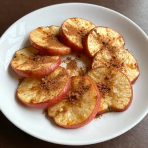 To make crispy cinnamon sugar apple chips, you need just a few simple items: - 2 large apples (such as Fuji or Honeycrisp) - 2 tablespoons granulated sugar - 1 teaspoon ground cinnamon - A pinch of salt - Cooking spray or parchment paper Choosing the right apples makes a big difference. I recommend: - Fuji: These apples are sweet and crisp. They hold their shape well when baked. - Honeycrisp: Known for their juicy texture, they add great flavor to your chips. - Gala: These apples are sweet and easy to slice thinly. They bake nicely too. If you want to change the sweetness, here are some options: - Maple syrup: Use less than sugar, as it is sweeter. - Honey: This can add a nice flavor, but you need to adjust the amount. - Coconut sugar: A lower-glycemic option that works well in this recipe. These ingredients come together to create a healthy snack that is fun to make. Enjoy the process and the tasty results! {{ingredient_image_1}} 1. Start by preheating your oven to 225°F (110°C). This low heat helps make the chips crispy. 2. Line a baking sheet with parchment paper or spray it lightly with cooking spray. This prevents sticking. 3. Wash and dry two large apples, like Fuji or Honeycrisp. 4. Use a sharp knife or mandoline slicer to cut each apple into thin slices, about 1/8 inch thick. You can keep the skin on for added texture and nutrients. 5. In a small bowl, mix 2 tablespoons of granulated sugar, 1 teaspoon of ground cinnamon, and a pinch of salt. Stir until well combined. 1. Lay the apple slices in a single layer on the prepared baking sheet. Make sure they do not overlap for even baking. 2. Evenly sprinkle the cinnamon sugar mixture over the apple slices. Coat them generously for the best flavor. 3. Bake the apple slices in the preheated oven for 1 to 1.5 hours. Turn them halfway through to ensure they crisp evenly. 4. Keep a close watch toward the end of baking. The apple chips should be dry and crispy but not burnt. 5. When finished, take them out and let them cool completely on the baking sheet. They will get even crispier as they cool. - Cut the apple slices as thin as possible. Thin slices bake better and crisp up nicely. - Make sure the slices are in a single layer. Overlapping can lead to soggy chips. - If you want extra crispiness, leave them in the oven a little longer, but watch closely to avoid burning. - Store cooled apple chips in an airtight container to keep them fresh. When making cinnamon sugar apple chips, avoid cutting the apples too thick. Thin slices, about 1/8 inch, help them crisp up nicely. Also, don’t overlap the apple slices on the baking sheet. Overlapping leads to soggy spots. Watch the baking time closely; every oven is different. If you bake them too long, they can burn quickly. To boost flavor, try using different apple types. Fuji and Honeycrisp work well, but tart apples like Granny Smith add a nice contrast. You can also add a touch of nutmeg or ginger to the cinnamon sugar mix. This small change can make a big difference. A little vanilla extract on the apple slices before baking adds a lovely aroma and flavor. Once your apple chips cool, store them in an airtight container. This keeps them crispy for up to a week. If you live in a humid area, consider adding a small packet of silica gel to absorb moisture. For longer storage, you can freeze the apple chips. Just make sure they are fully dry before freezing. Pro Tips Choose the Right Apples: Opt for sweet and crisp varieties like Fuji or Honeycrisp for the best flavor and texture. Slice Evenly: Use a mandoline slicer for uniform thickness, ensuring even baking and crispiness throughout. Monitor Baking Time: Keep an eye on your apple chips during the last 15 minutes of baking to prevent burning. Store Properly: To maintain crispness, make sure the apple chips are completely cool before storing them in an airtight container. {{image_2}} You can easily change the flavor of your apple chips. Try adding caramel flavoring for a sweet twist. Mix in some pumpkin spice for a cozy fall taste. A sprinkle of nutmeg or ginger can also add warmth. Experiment with different spices to find your favorite blend. While apples are great, you can also use other fruits. Pears work well and have a nice sweetness. Bananas can add a unique flavor and chewiness. Try using peaches or mangoes for a tropical flair. Each fruit brings its own taste, so have fun mixing it up! Dipping can make your apple chips even better. Pair them with peanut butter for a protein boost. Greek yogurt adds creaminess and tang. You can also try a honey drizzle for extra sweetness. These dips can enhance the flavor and make your snack more filling. Apple chips are not just tasty; they are also good for you. Apples are full of fiber, which helps your digestion. One large apple has about 4 grams of fiber. This can help you feel full and may aid in weight control. Apples also hold vitamins like Vitamin C, which supports your immune system. The cinnamon adds flavor and may help with blood sugar control. This snack is low in fat and calories, making it a healthy choice. When you look at snacks, apple chips stand out. Many chips or cookies are high in sugar and fat. For example, a bag of regular potato chips has about 10 grams of fat per serving. In contrast, a serving of apple chips has less than 2 grams of fat. It’s a great swap if you want something crunchy and sweet without the extra calories. Snack bars may seem healthy, but they often have added sugars. Apple chips keep it simple and natural. A good portion size for apple chips is about 1 ounce. This is roughly equal to 1 medium apple. You can enjoy this amount without feeling guilty. If you're sharing, consider serving 2 to 3 ounces for a group. Just keep in mind that while they are healthy, they still have sugar. Eating in moderation helps you enjoy the flavor without overdoing it. Homemade apple chips stay fresh for about a week. Store them in an airtight container. This keeps them crunchy. If they get soft, you can bake them again for a few minutes. Yes, you can. Just slice the apples and bake them. If you want flavor, try adding spices like cinnamon or nutmeg. You can also use a bit of honey or maple syrup. Yes, apple chips are gluten-free and vegan. They contain only apples and spices. This makes them a great snack for many diets. Just check the sugar if you add any. You can find them in most grocery stores. Look in the snack aisle or near dried fruits. Online stores also sell them. Check brands that focus on healthy snacks for the best options. You learned how to make delicious apple chips at home. We covered the best apples and sweeteners. I shared step-by-step steps and tips for baking them crispy. You now know common mistakes and ways to boost flavor. We also explored fun variations and storage tips. Finally, I highlighted their health benefits compared to other snacks. Making apple chips is easy and fun. Enjoy the crunch and flavor of your homemade snack!
